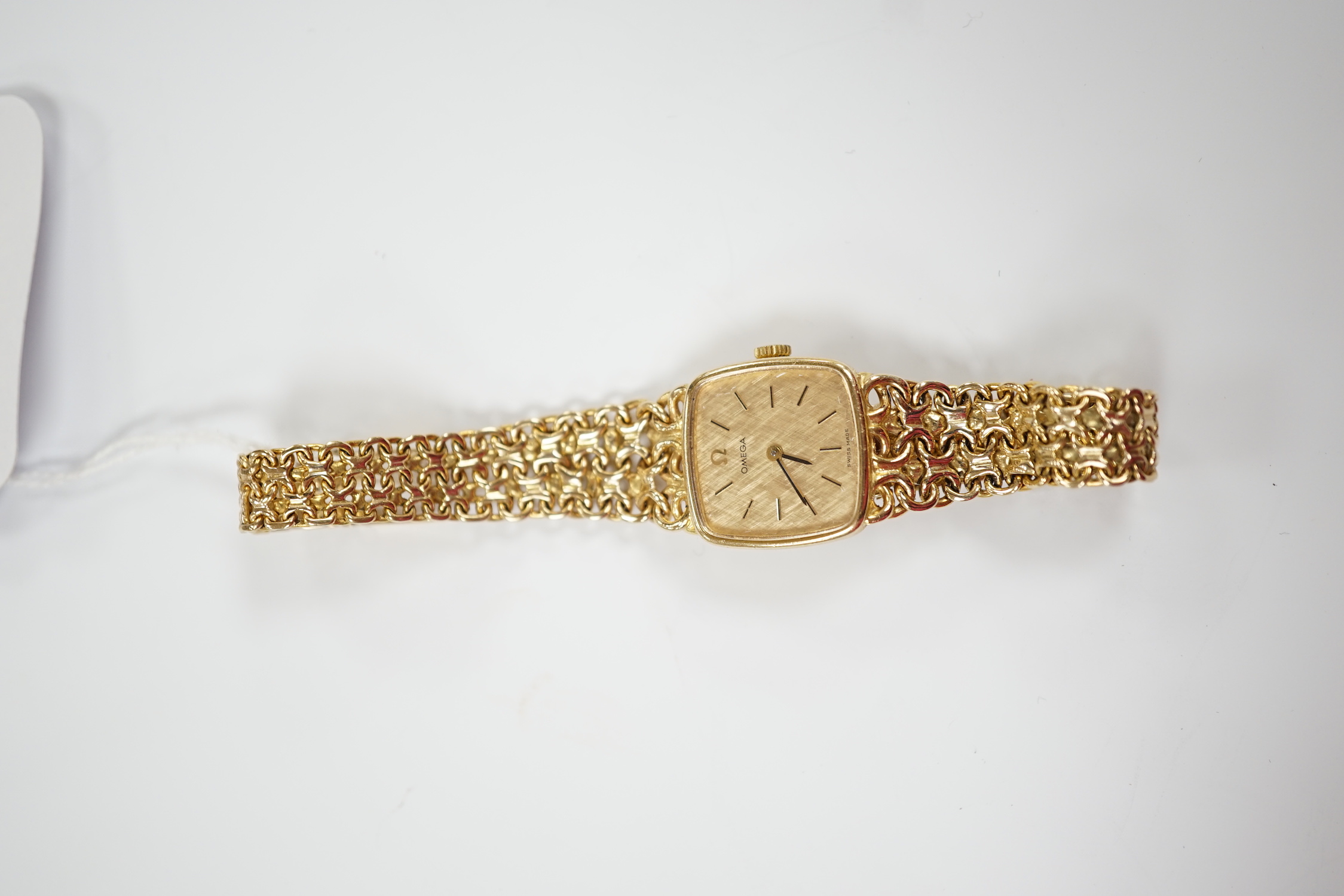 A lady's 1970's 9ct gold Omega manual wind wrist watch, on integral Omega 9ct gold bracelet, approximately 16cm, gross weight 28.1 grams.